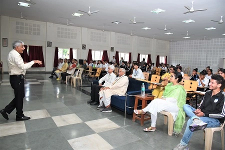 caption-1-Dr.Vijendra-Chauhan-addressing-students-on-holistic-health-and-yoga