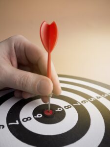 high-angle-hand-putting-dart-bull-s-eye